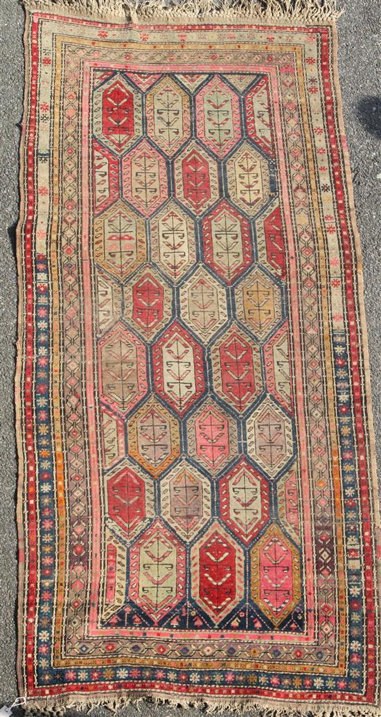 A Kazak multi-coloured rug, late 19th century, 8ft 8in by 3ft 10in.